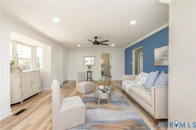 a living room with furniture and wooden floor