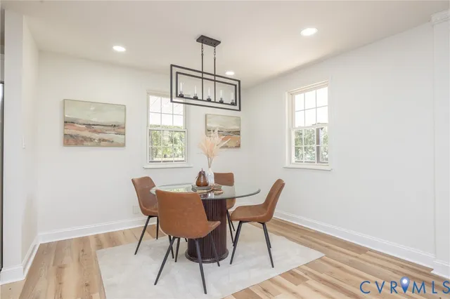 a dining room with furniture a rug and a window