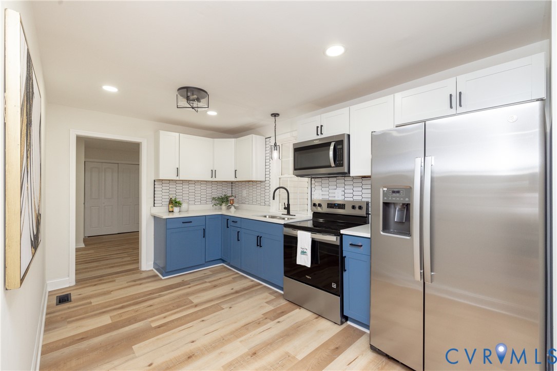 5318 Pine Hill Road Sutherland, VA 23885 - Photo 10 of 50 a kitchen with stainless steel appliances cabinets a sink and a counter top space