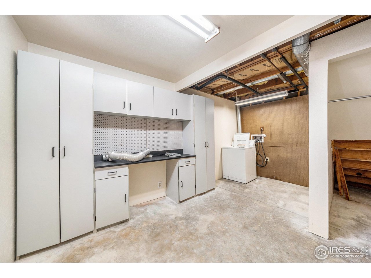 2167 Hackberry Circle Longmont, CO 80501 - Photo 21 of 23 a kitchen with white cabinets and white appliances