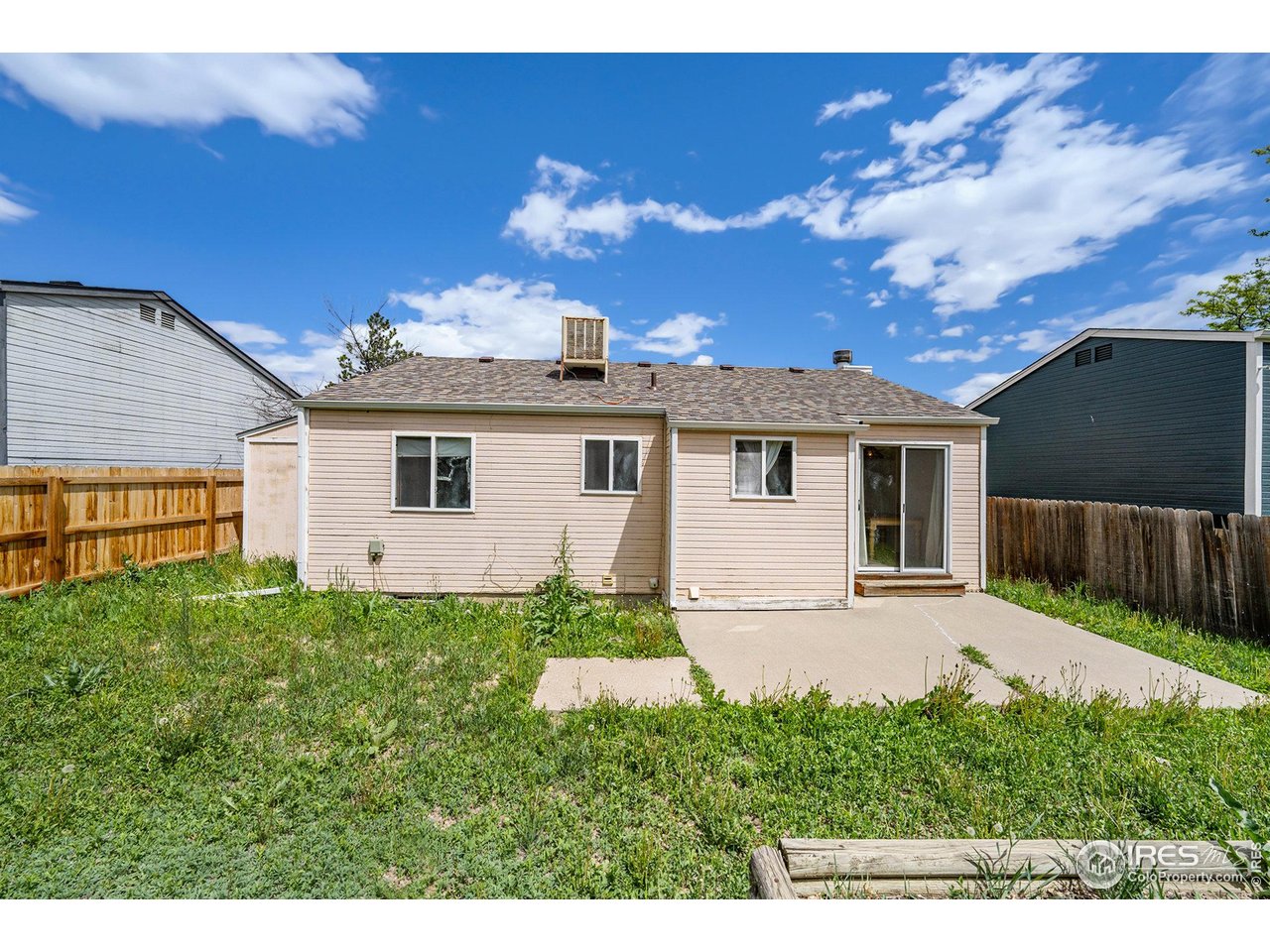 2167 Hackberry Circle Longmont, CO 80501 - Photo 22 of 23 a view of a house with a yard