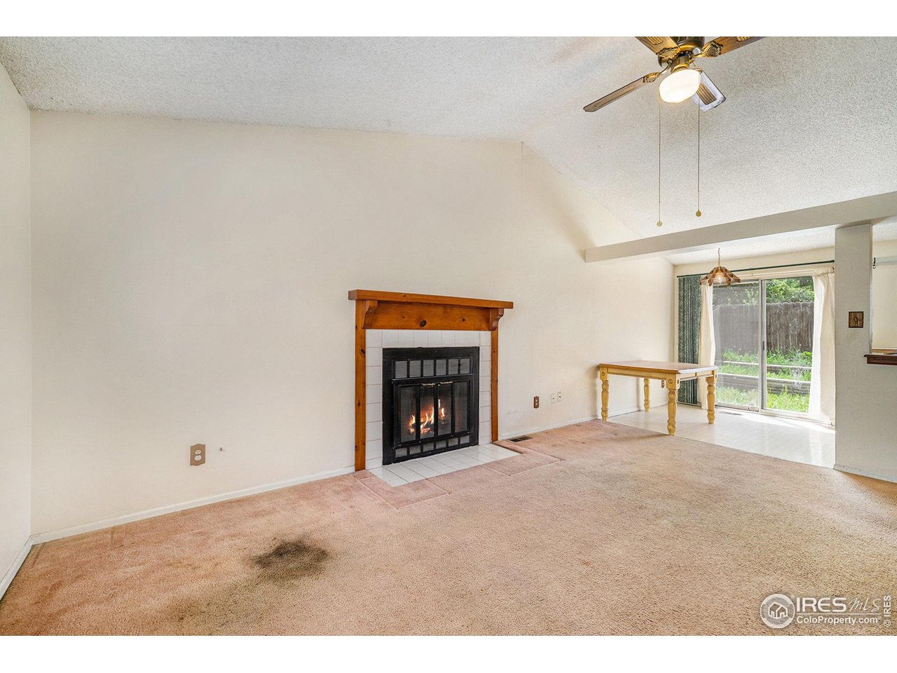 2167 Hackberry Circle Longmont, CO 80501 - Photo 4 of 23 a view of an empty room with a fireplace and a window
