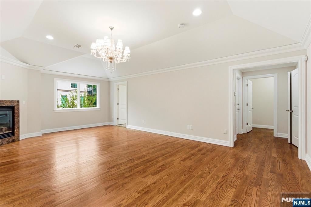 767 Orangeburgh Road River Vale, NJ 07675 - Photo 32 of 49 an empty room with wooden floor chandelier and windows