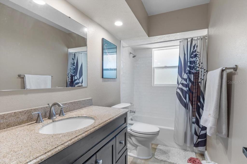 7226 Alafia Ridge Loop Riverview, FL 33569 - Photo 24 of 51 a bathroom with a granite countertop sink toilet and shower
