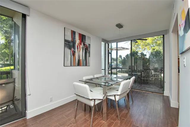 a dining room with furniture window and wooden floor