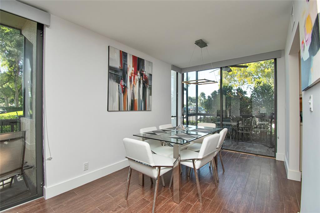 1612 Bridgewood Drive, Unit 1612 Boca Raton, FL 33434 - Photo 12 of 38 a dining room with furniture window and wooden floor