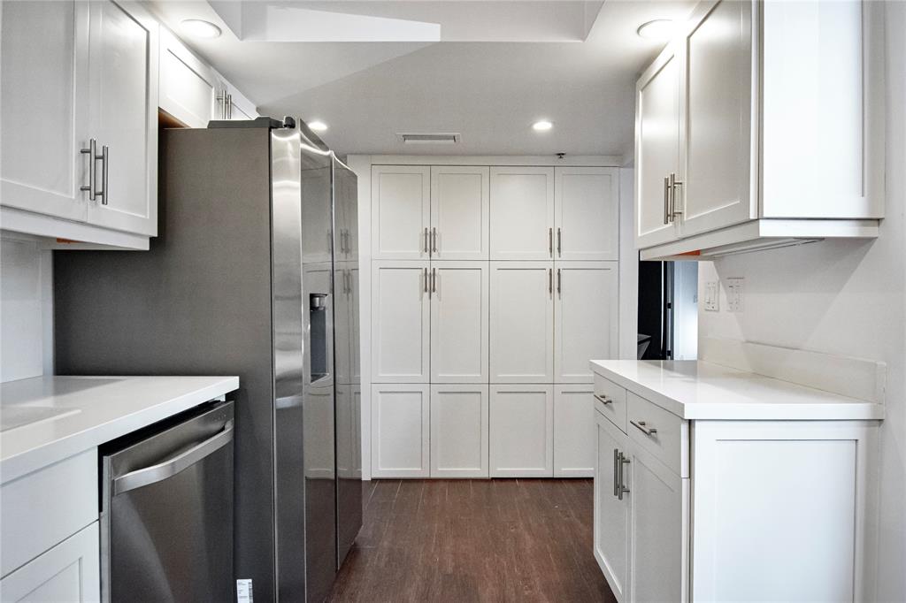 1612 Bridgewood Drive, Unit 1612 Boca Raton, FL 33434 - Photo 20 of 38 a kitchen with a refrigerator sink and cabinets