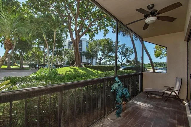 a view of a porch with furniture and a yard