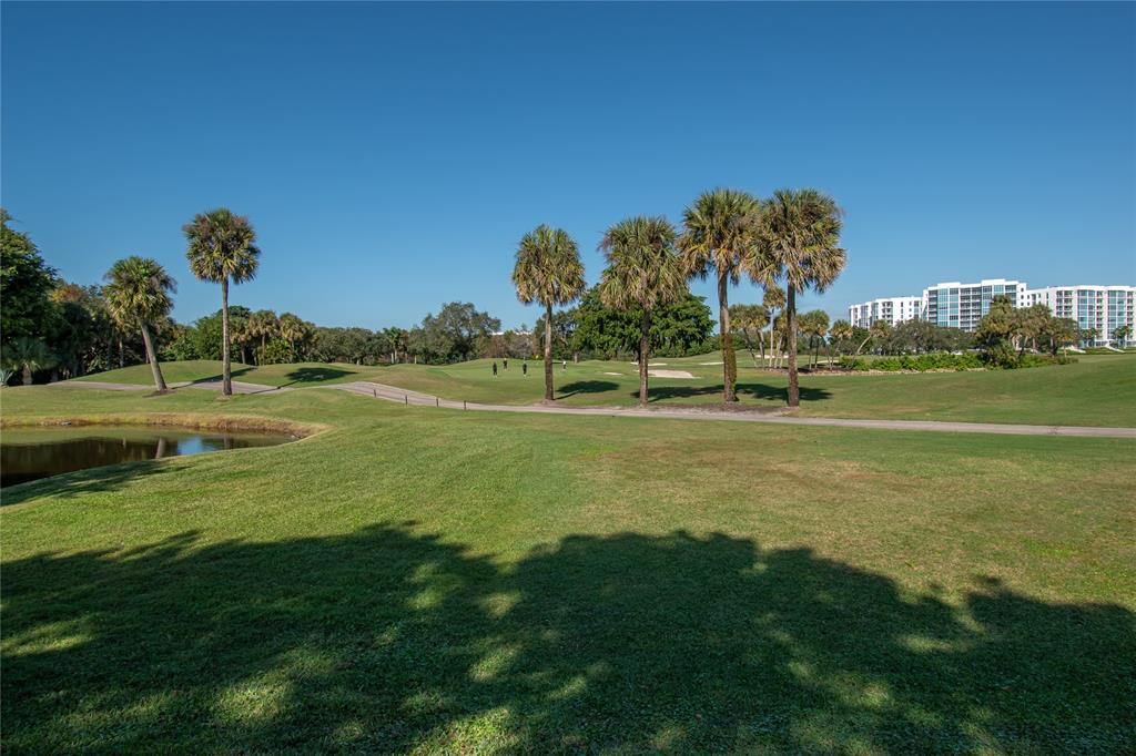 1612 Bridgewood Drive, Unit 1612 Boca Raton, FL 33434 - Photo 34 of 38 a view of a golf course with a lake