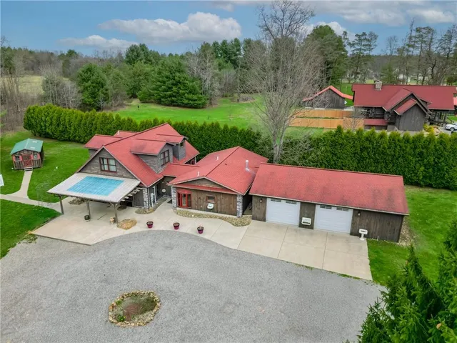 an aerial view of a house with pool outdoor seating and yard