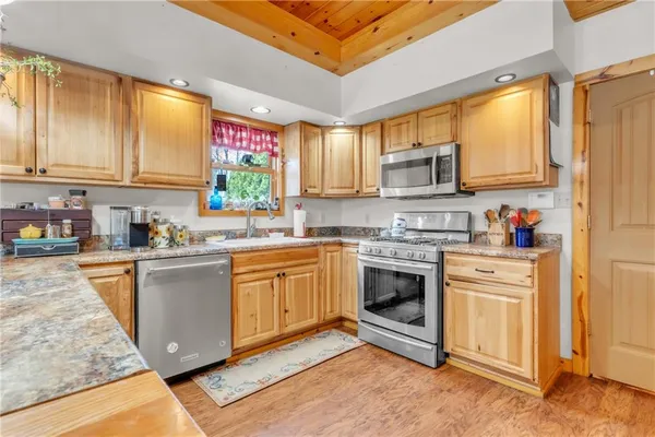 a view of living room kitchen island with furniture and wooden floor
