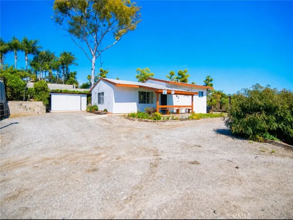a front view of a house with a yard and a garage