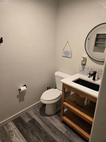 a bathroom with a sink a toilet and a mirror