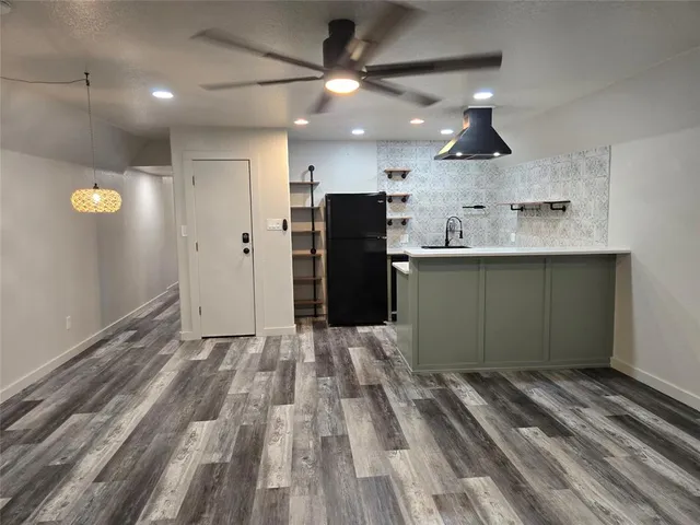 a kitchen with kitchen island a sink stainless steel appliances and cabinets
