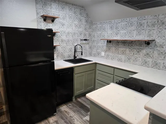 a kitchen with a sink and a refrigerator