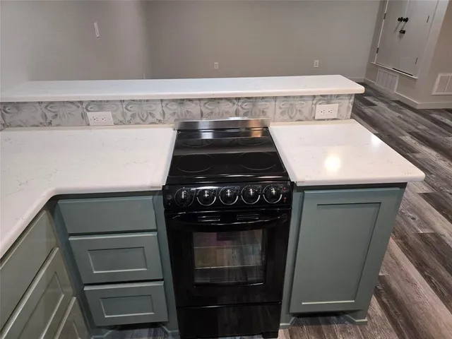 a stove top oven sitting inside of a kitchen