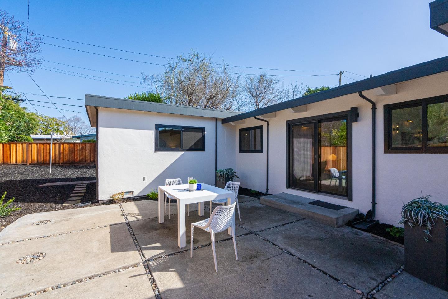 369 Ruth Avenue Mountain View, CA 94043 - Photo 27 of 33 a view of a patio with table and chairs and potted plants