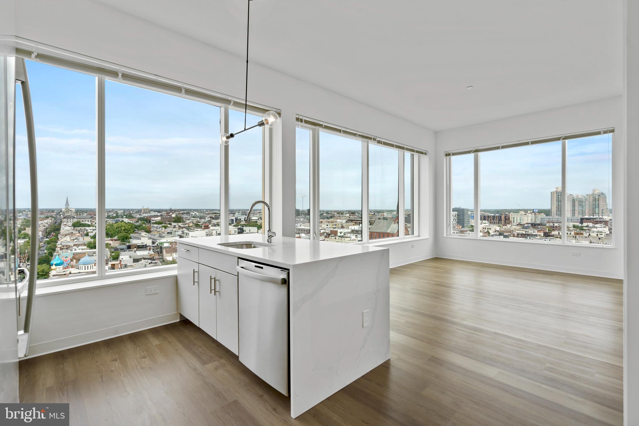 569 North 5th Street, Unit 723 Philadelphia, PA 19123 - Photo 1 of 49 a kitchen with a large window and wooden floor