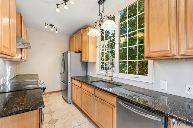 a kitchen with granite countertop a sink and a stove