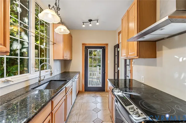 a kitchen with a sink stove and cabinets