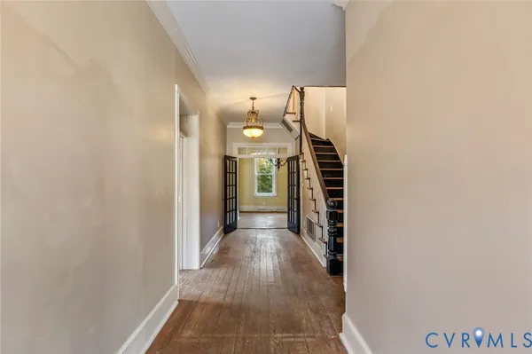 a view of a hallway with wooden floor