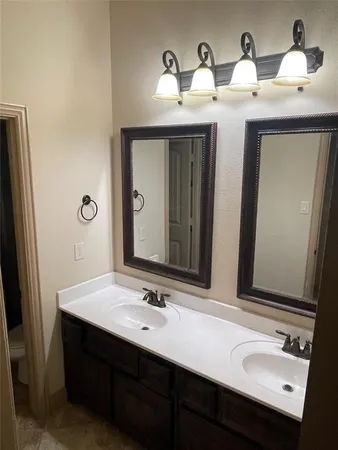 a bathroom with a double vanity sink and a mirror