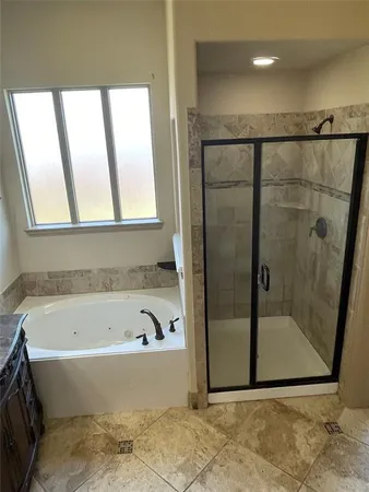 a bathroom with a bathtub and a shower