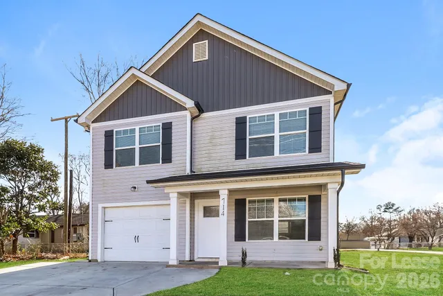 a view of house with yard