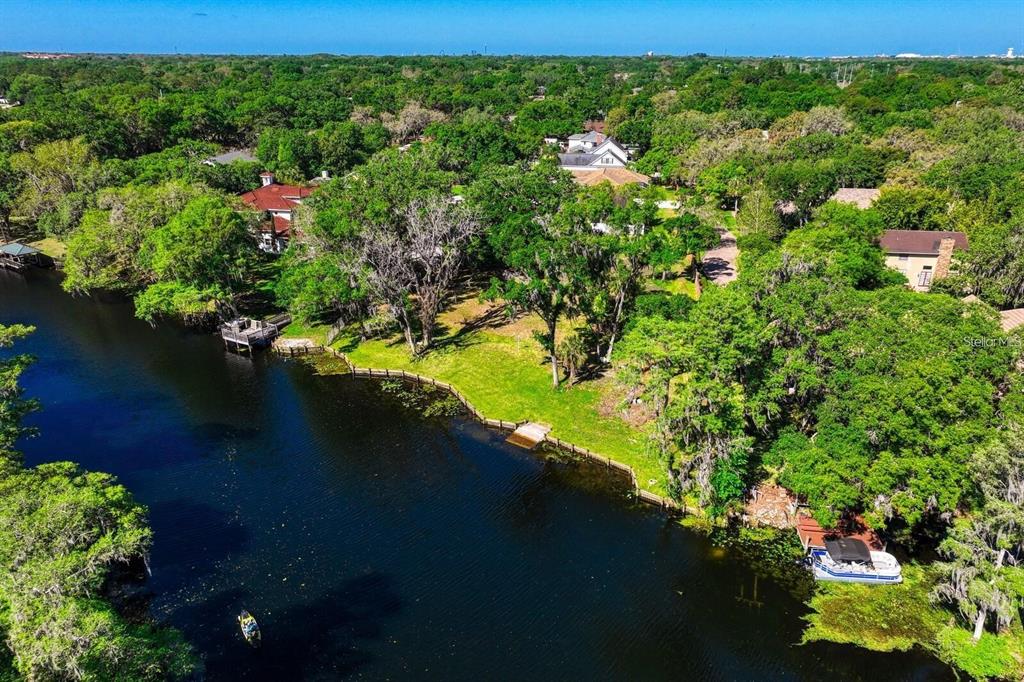 7810 Terrace Oaks Court Temple Terrace, FL 33617 - Photo 14 of 18 a view of a lake with a yard