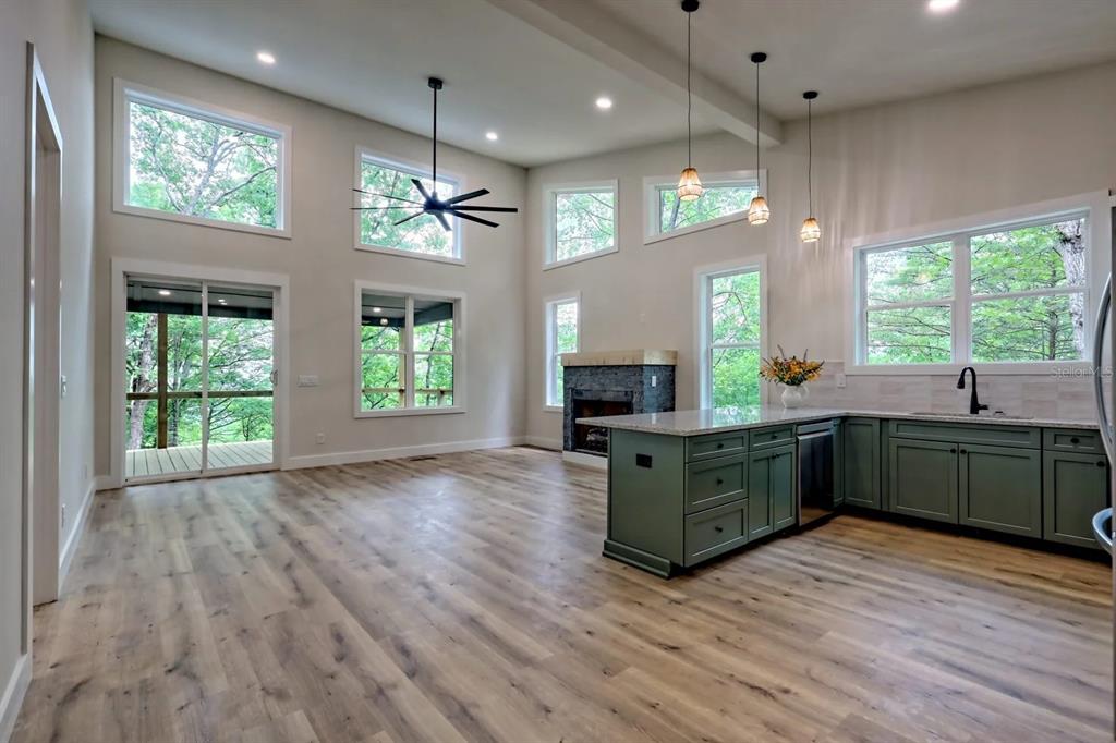 7810 Terrace Oaks Court Temple Terrace, FL 33617 - Photo 3 of 18 a kitchen with kitchen island granite countertop a sink window and wooden floor