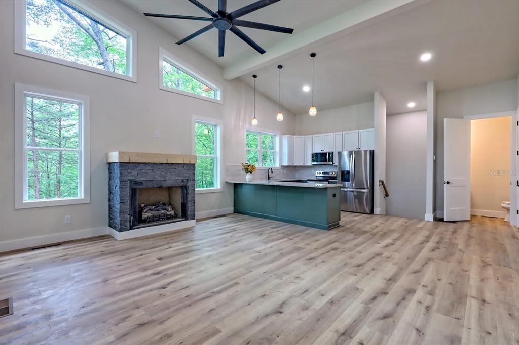 7810 Terrace Oaks Court Temple Terrace, FL 33617 - Photo 6 of 18 a open kitchen with kitchen island a stove a sink dishwasher and a fireplace