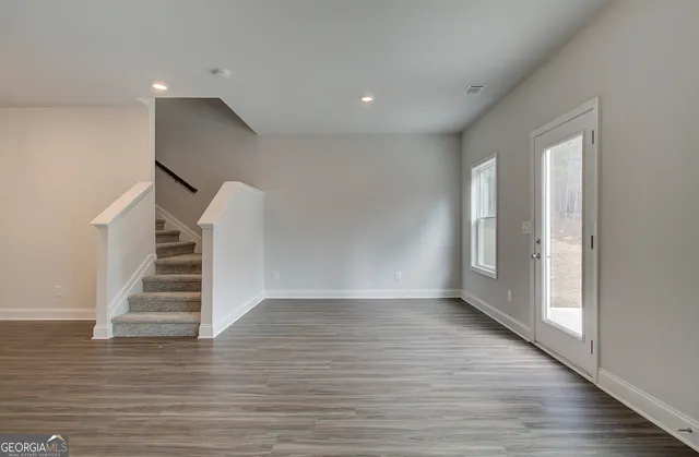 a view of an entryway with wooden floor