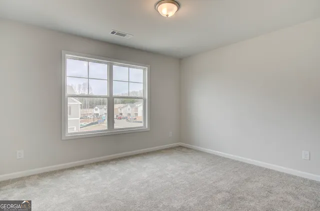 a view of a room with wooden floor and white walls