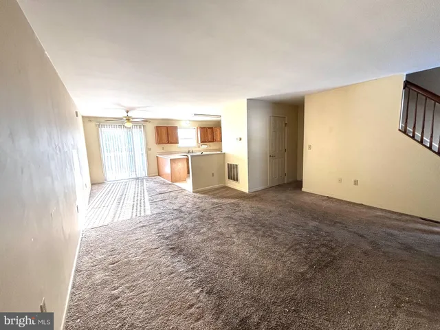 a view of a bedroom with a refrigerator cabinet and a window