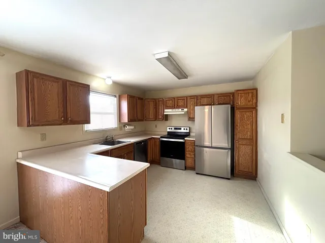 a kitchen with a sink a stove and refrigerator