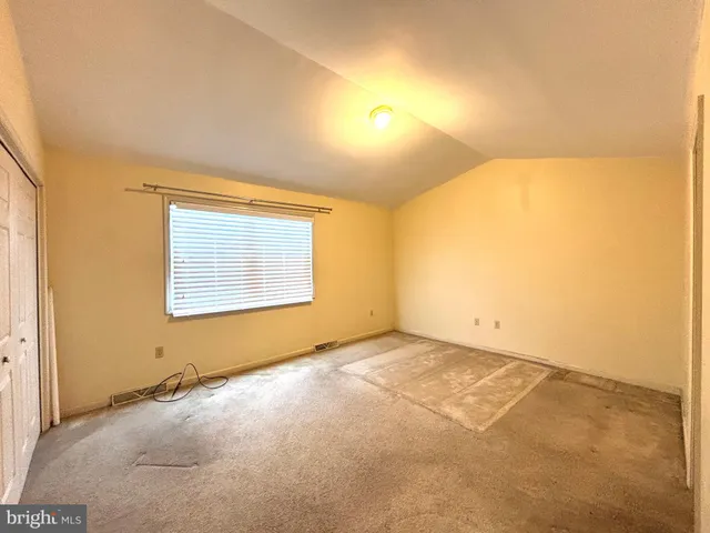an empty room with a empty space and windows