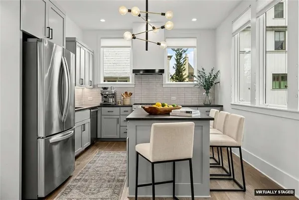 a view of a hallway with wooden floor and stairs
