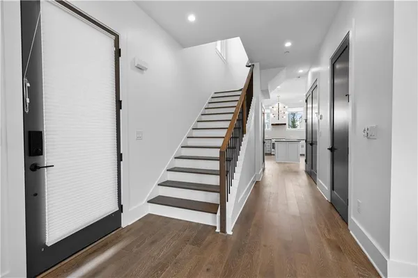 an empty room with wooden floor and a window