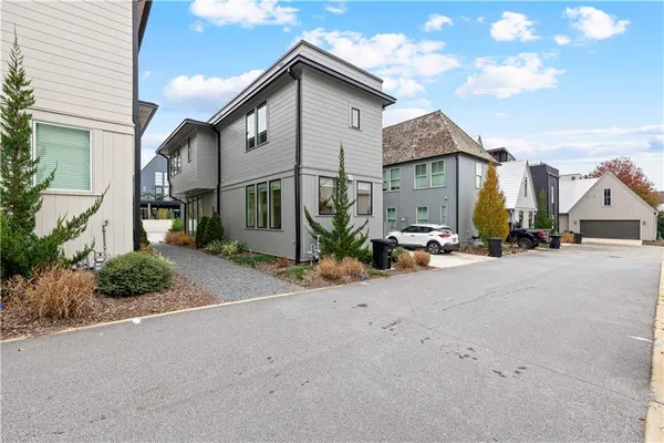 a view of a street with cars parked in front of it