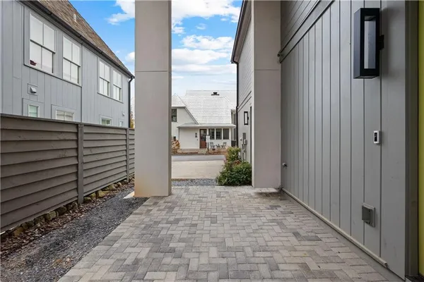 a view of an empty room with wooden floor fireplace and a window