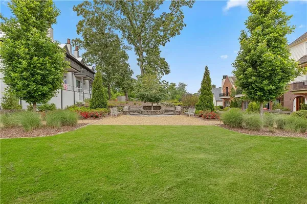 a front view of a house with yard and trees