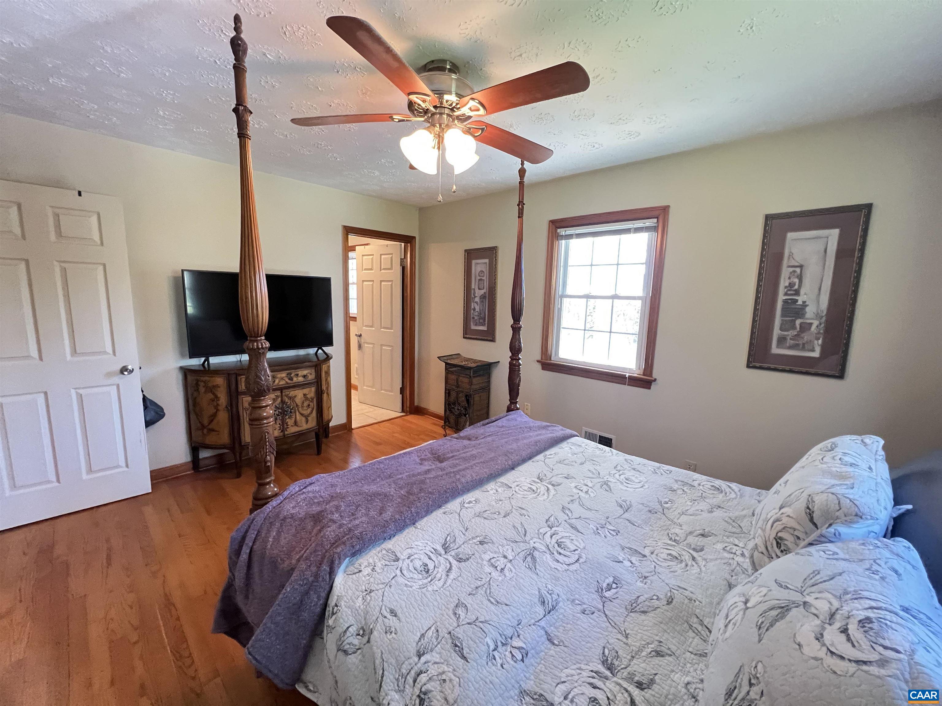 3515 Richmond Road Keswick, VA 22947 - Photo 16 of 47 a bedroom with a bed and a flat screen tv