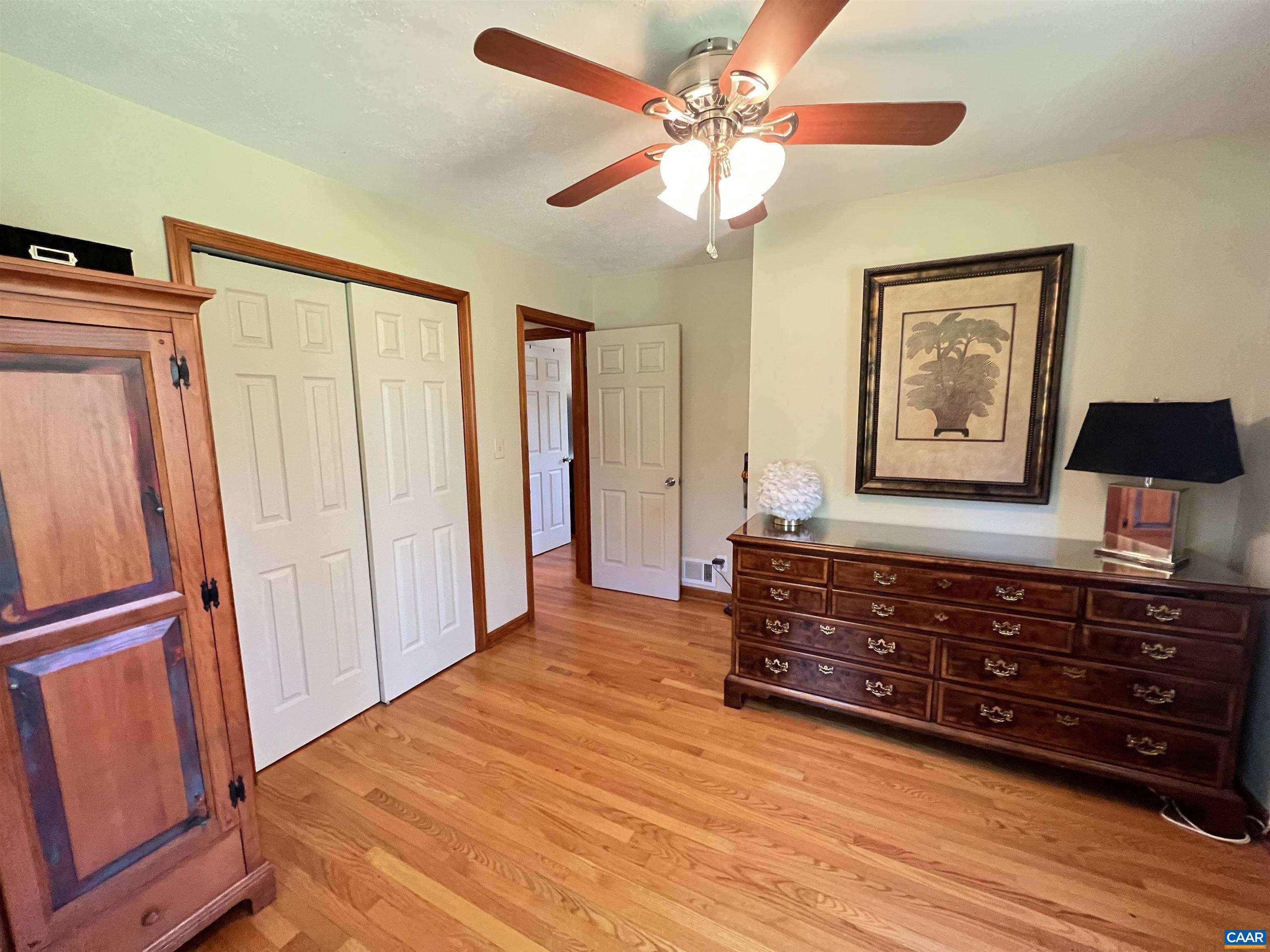3515 Richmond Road Keswick, VA 22947 - Photo 19 of 47 a view of a bedroom with wooden floor and cabinet