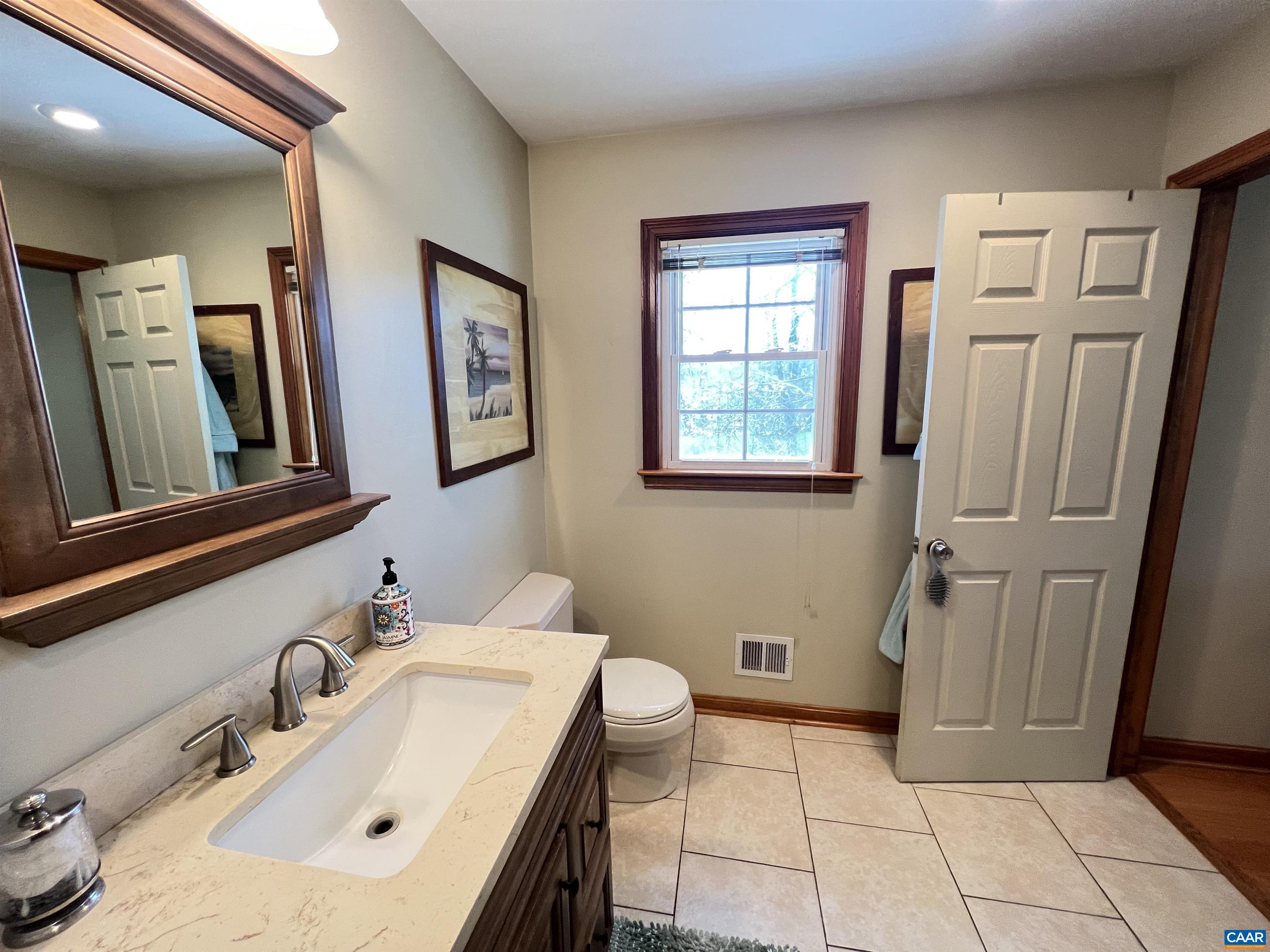 3515 Richmond Road Keswick, VA 22947 - Photo 23 of 47 a bathroom with a sink a toilet and a mirror