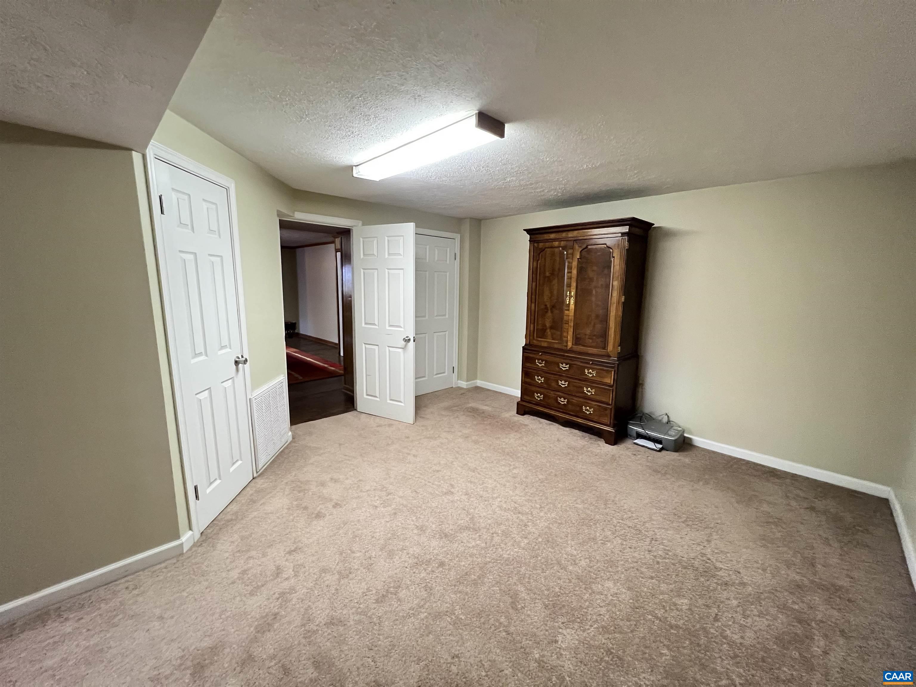 3515 Richmond Road Keswick, VA 22947 - Photo 31 of 47 an empty room with closet and wooden door
