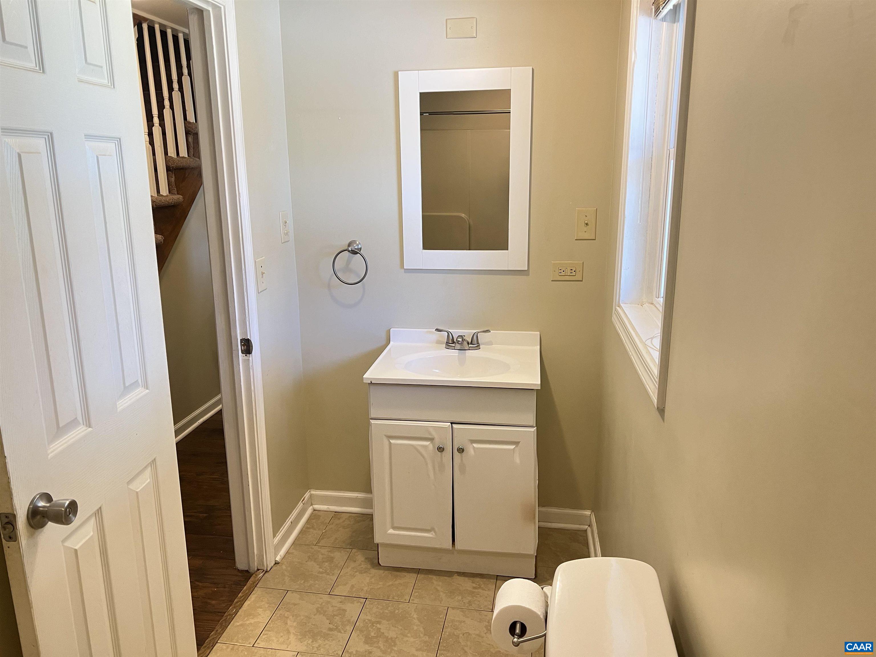 3515 Richmond Road Keswick, VA 22947 - Photo 32 of 47 a bathroom with a sink a toilet a shower and a mirror