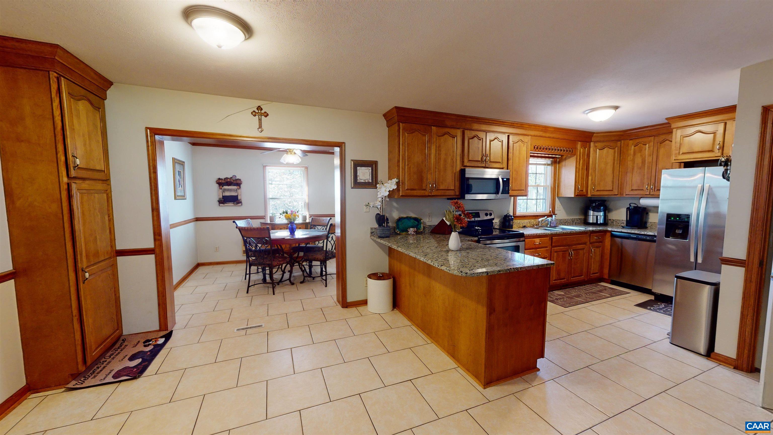3515 Richmond Road Keswick, VA 22947 - Photo 7 of 47 a kitchen with stainless steel appliances granite countertop a stove a sink a refrigerator and a dining table
