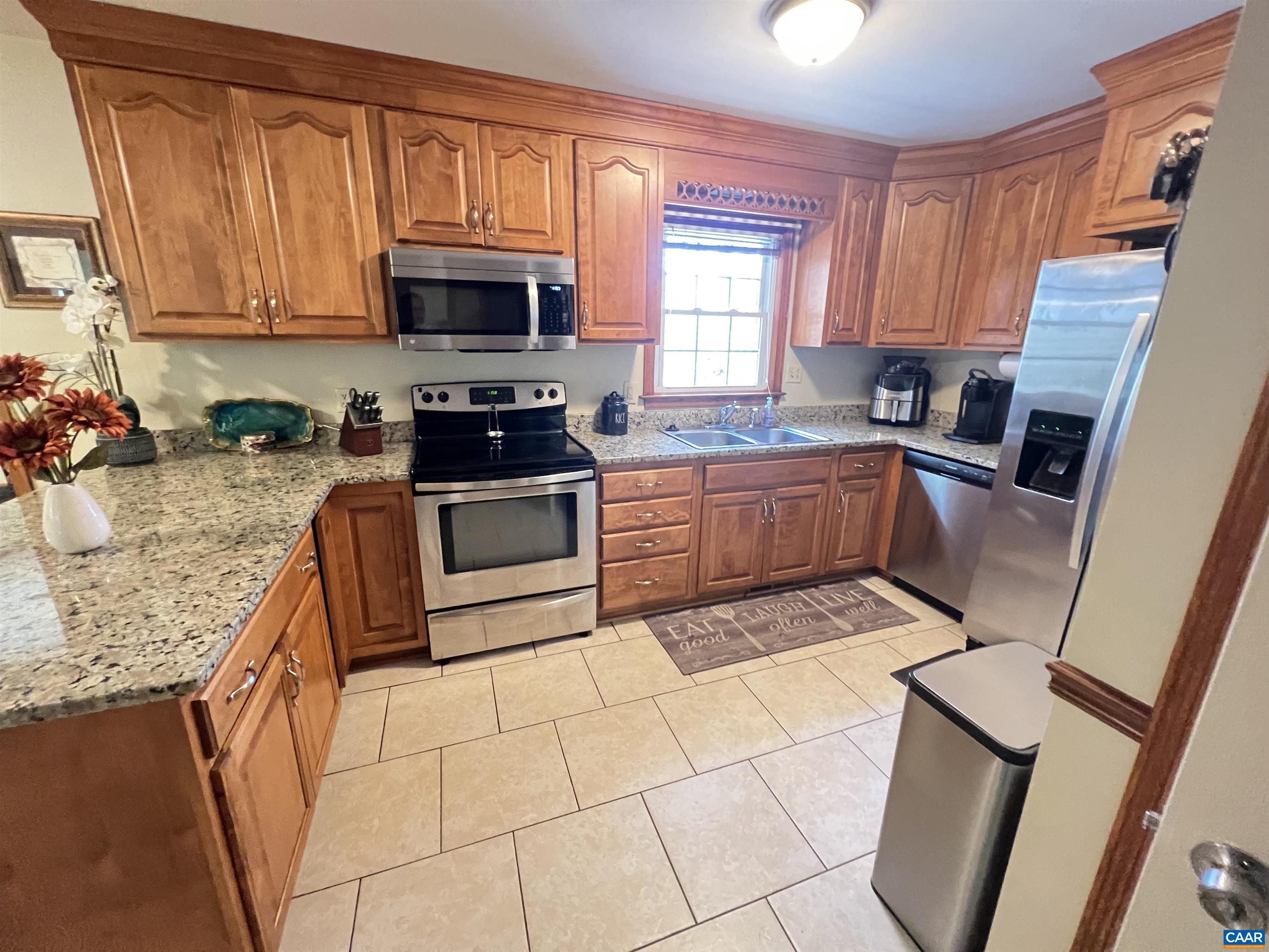 3515 Richmond Road Keswick, VA 22947 - Photo 8 of 47 a kitchen with granite countertop a stove a sink and a microwave