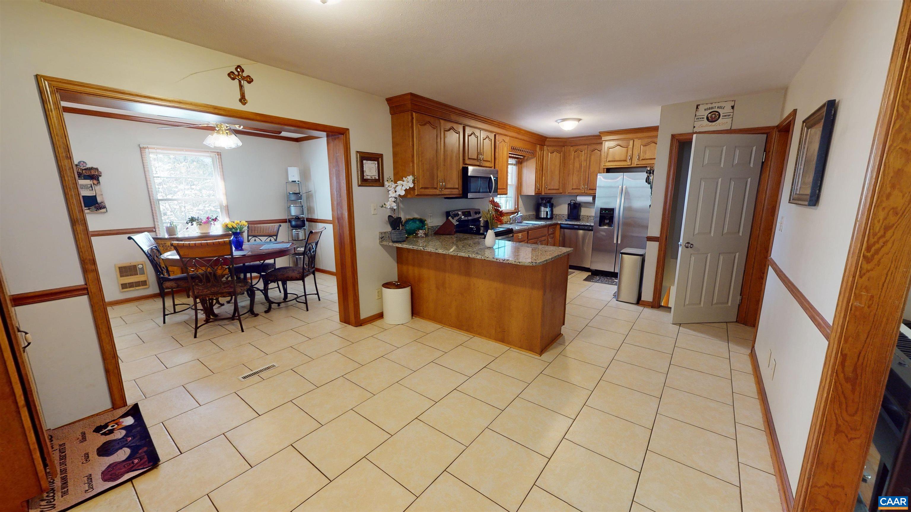 3515 Richmond Road Keswick, VA 22947 - Photo 10 of 47 a view of a kitchen with furniture and a refrigerator