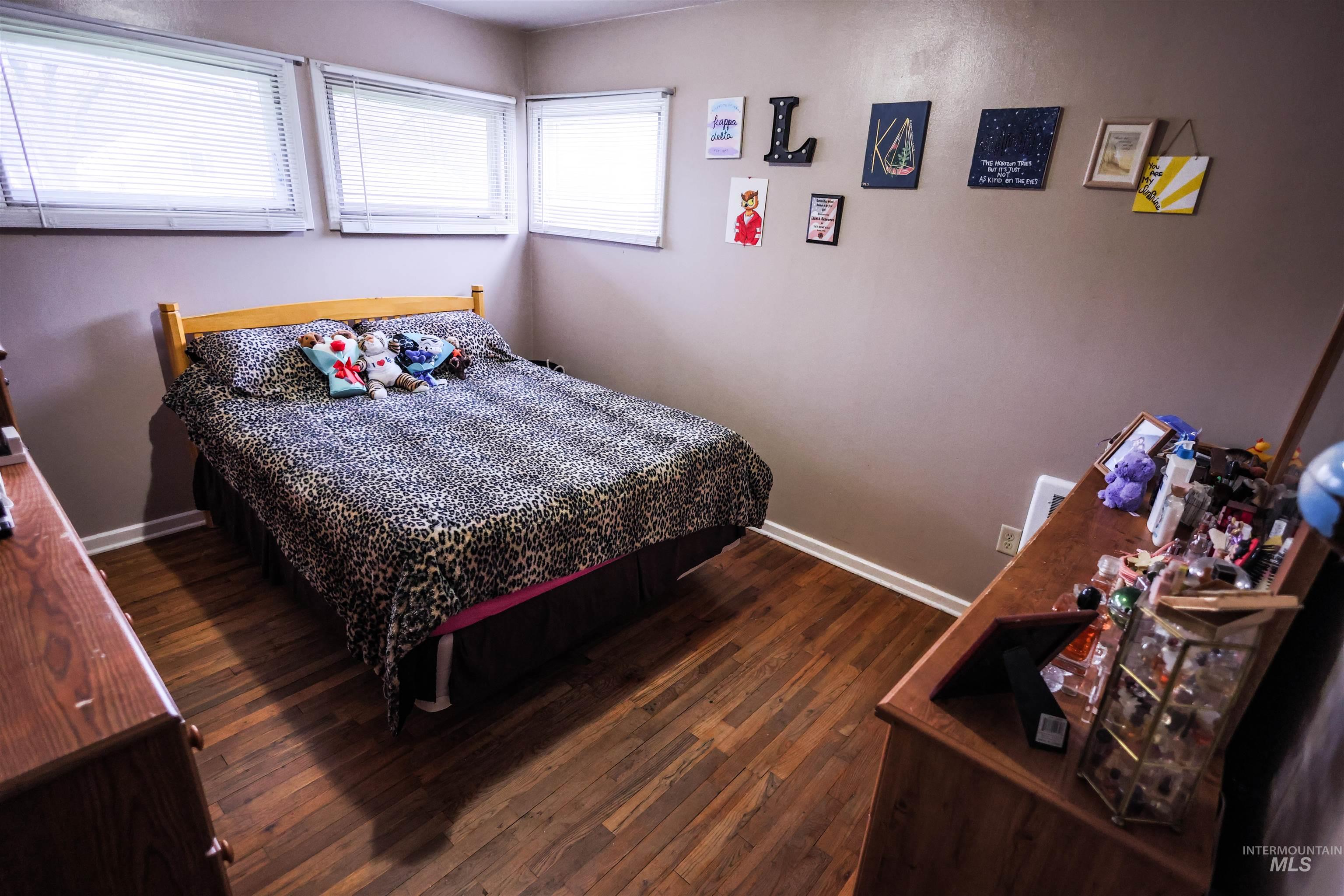 712 Hill Street Kamiah, ID 83536 - Photo 25 of 41 Bedroom featuring dark wood-style floors and baseboards